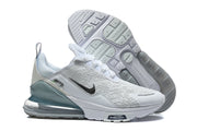 Pair of white Nike Air Max 270 Premium sneakers showing the outsole and teal-toned heel units.