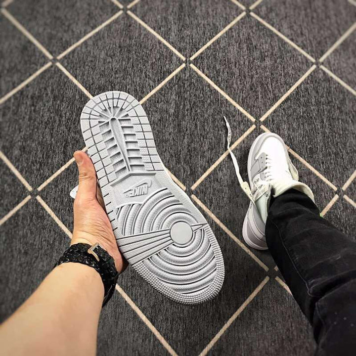 Close-up of the grey outsole with circular traction grooves and a visible Nike mark.