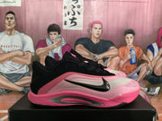 Side profile highlighting the black collar, pale upper, pink outsole and side detailing.