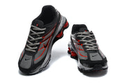 Front and top views of the Nike Shox Ride 2 sneakers with grey laces and red side detailing.