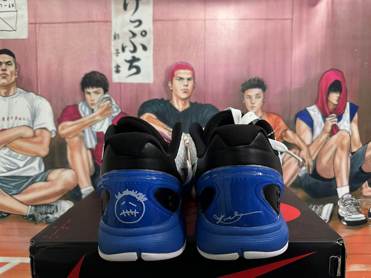 Rear view of black, white, and blue basketball sneakers displayed on a shoebox.