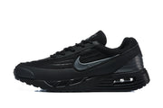 Side profile of a black Nike Air Max sneaker with a dark Swoosh and visible heel cushioning unit.