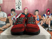 Front view of red and black basketball shoes with patterned uppers and contrasting laces.