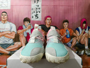 Front view of the sneakers showing pale blue textured toe panels, grey overlays, pink laces and white outsoles.