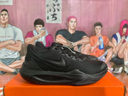 Side view of black Nike sneakers showing the textured upper, side Swoosh and layered outsole.