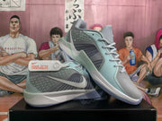 Three-quarter view of the Nike basketball sneakers showing layered side panels, Swoosh branding, laces, and contrasting midsoles.