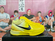 Side view of a yellow basketball sneaker showing the black Swoosh, padded collar, and speckled midsole.