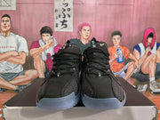 Front view of black Nike sneakers with white branding details and blue translucent outsoles.