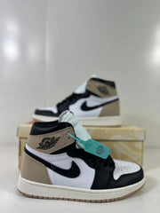 Close side view of one high-top sneaker showing the perforated toe box, black Swoosh, padded collar, and layered panels.