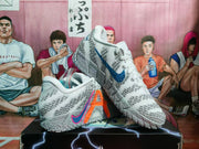 Angled view of the gray Nike basketball sneakers showing contrasting blue and orange accents and the patterned outsole.