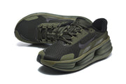 Angled view of a pair of olive and black Nike running shoes.