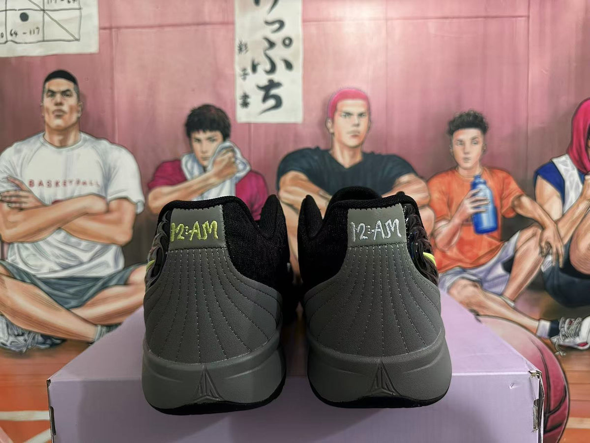 Rear view of black and gray Nike sneakers showing padded collars, stitched heel panels, and gray soles.