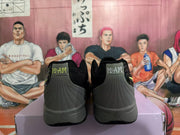 Rear view of black and gray Nike sneakers showing padded collars, stitched heel panels, and gray soles.