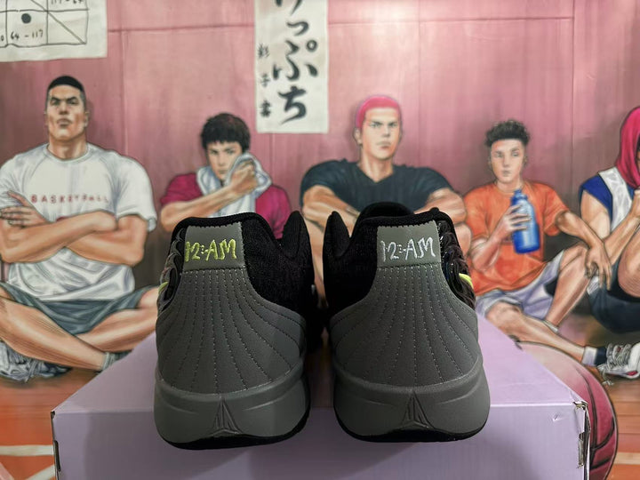 Rear view of black and gray Nike sneakers showing padded collars, stitched heel panels, and gray soles.