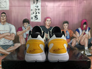 Rear view of off-white Nike Kobe basketball shoes with gold heel panels and black collar lining.