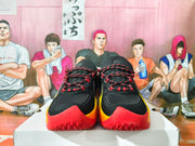 Front view showing black toe boxes, red-and-black laces, yellow side accents, and red outsoles.