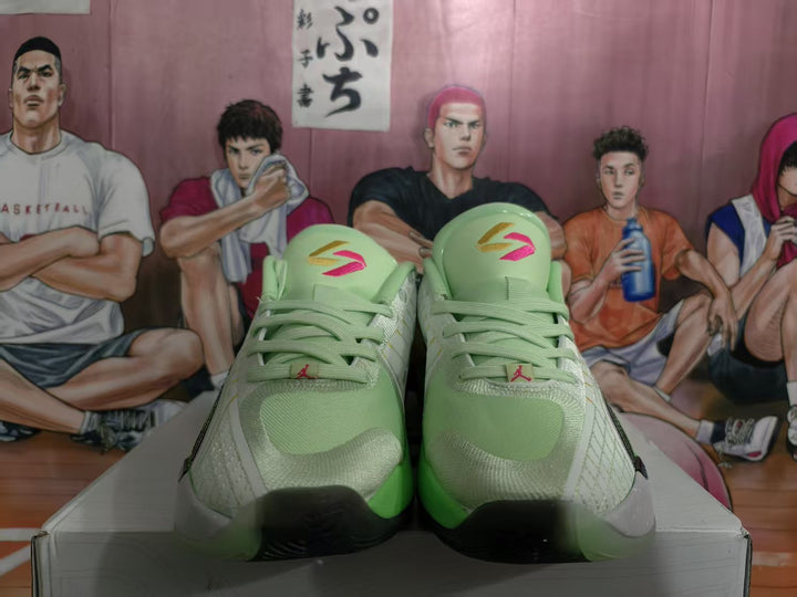 Front view of green and gray Jordan basketball sneakers with black accents and Jumpman tongue branding.