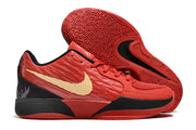 Red Nike Ja 2 shoe with gold side logo beside the patterned outsole