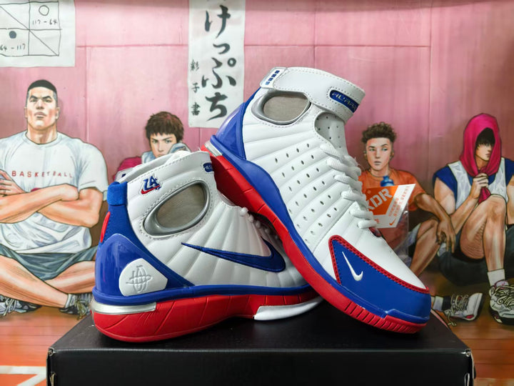 Pair of white Nike high-top basketball shoes with blue and red accents, shown from the side.