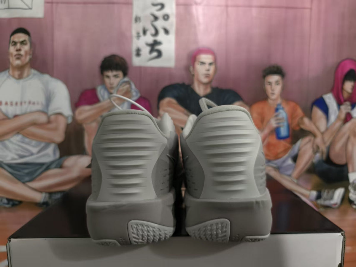 Rear view of grey Nike sneakers showing the ridged heel design and textured outsole.