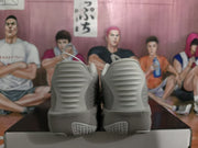 Rear view of grey Nike sneakers showing the ridged heel design and textured outsole.