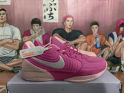 Side view of a magenta and pale pink Nike sneaker showing the silver Swoosh, layered side panels, laces, and a product tag.
