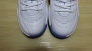 Top-down close-up of the white textured toe boxes and blue outsole edges.