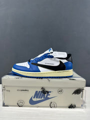 Single blue and white low-top sneaker shown in profile on its box.