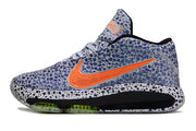 Side profile of blue-patterned Nike GT Hustle 3 with orange Swoosh and black sole accents.