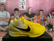 Side profile of a yellow Nike basketball sneaker with a black Swoosh, perforated toe area and speckled midsole.