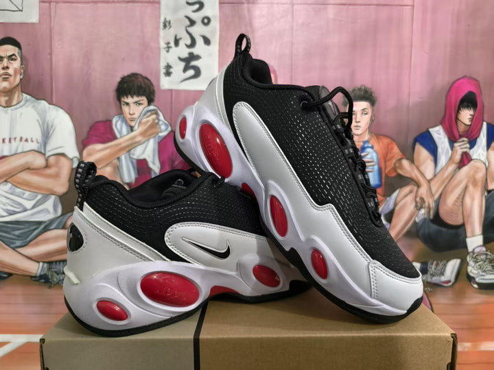 Pair of black, white, and red Nike sneakers shown from a three-quarter angle on a box.