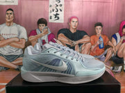 Side profile of a pale blue Nike basketball sneaker showing the Swoosh, layered mesh-like panels, tonal laces, and molded midsole details.