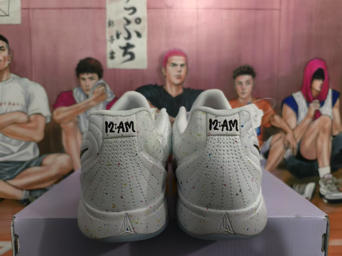 Rear view of white speckled Nike sneakers showing printed heel markings, textured panels, and translucent outsoles.