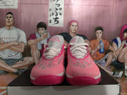 Front view showing the paired sneakers, white laces, pink patterned uppers, and contrasting soles.