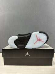 Underside view of the sneaker showing the translucent patterned outsole and visible Nike branding.