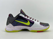 Side profile emphasizing the iridescent purple panels and green outsole.