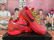 Angled display of paired red Nike basketball sneakers with black Swooshes, bright green laces, textured uppers, and translucent heel details.