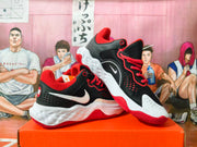 Angled view of the black and red Nike sneakers displaying the side Swoosh, perforated heel panels, and textured midsole.