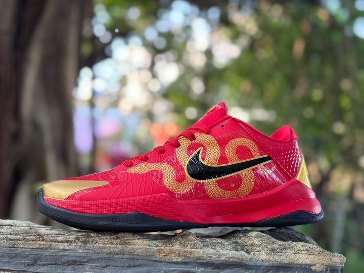 Side view of red and gold Nike Kobe 5 basketball shoes