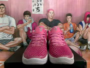 Front view of the pair showing pink textured uppers, matching laces, white toe midsoles, and tongue logos.