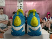 Rear view showing yellow heel panels, blue uppers, and AE1 LOW lettering