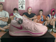 Side profile of a pink sneaker with a dark pink swoosh, sculpted side panels, and tonal outsole.