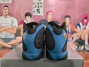 Rear view of black and blue Jordan basketball sneakers with dotted side panels