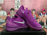 Angled view of two purple Nike basketball sneakers displaying the silver Swoosh, laces, heel details, and purple soles.