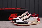 Pair of black, white, red, and cream low-top sneakers displayed with a branded black shoebox.
