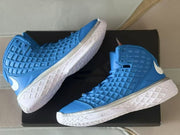 Close angled view highlighting the raised geometric upper and white midsole.