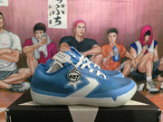 Side view showing the blue textured upper, white graphic, circular “007” detail, and light-colored sole.