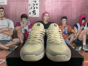 Pair of gray and pale yellow Nike Kobe basketball shoes viewed from the front