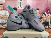 Pair of gray Nike basketball shoes showing the side panels, laces, and forefoot straps