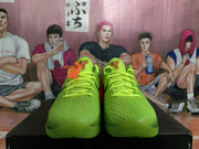 Front view of vivid green Nike Kobe basketball shoes with textured uppers and neon laces